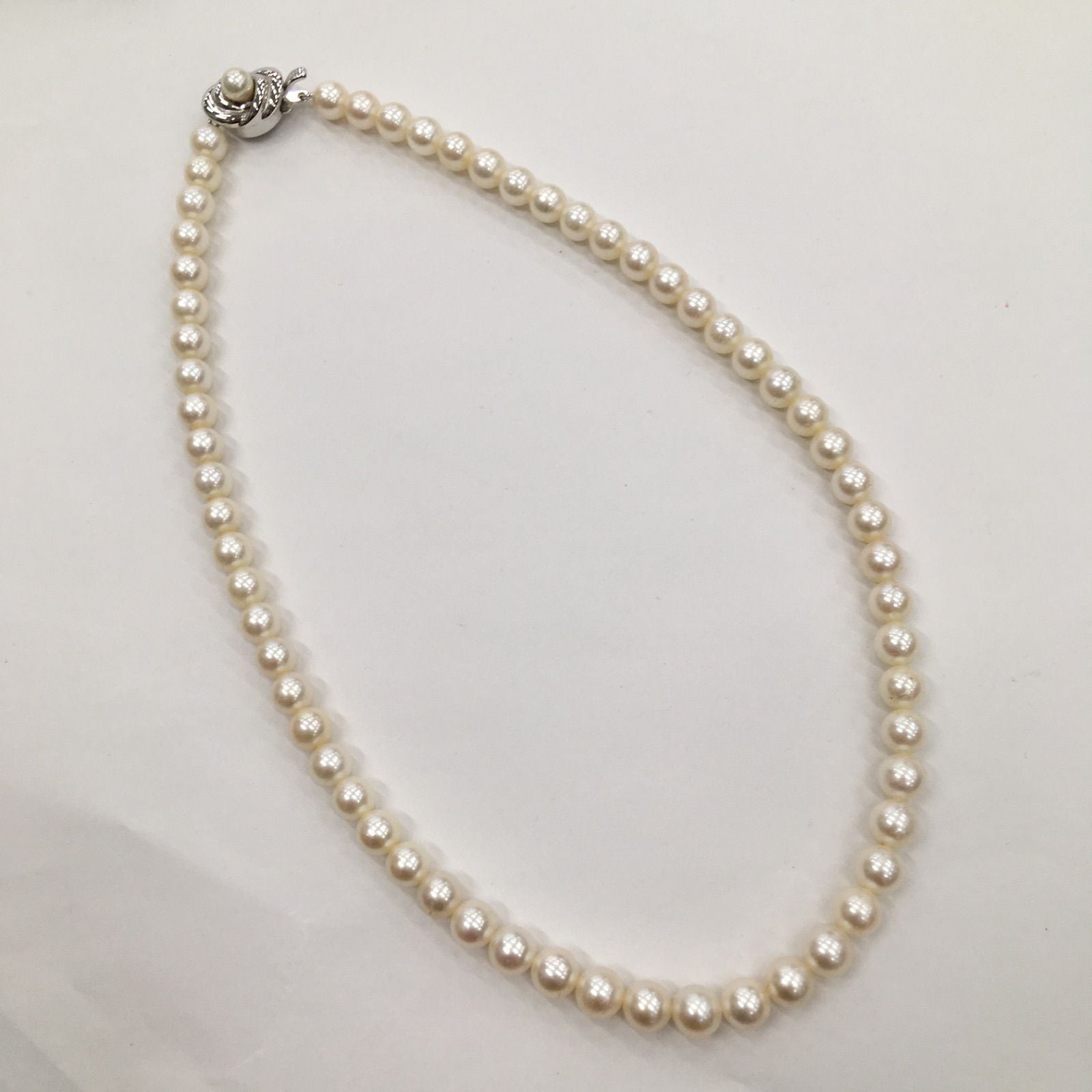 Tasaki Pearl Necklace featuring 7mm pearls in 19cm and 38cm lengths on display