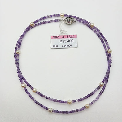 Akoya baby pearl and amethyst necklace with cream pearls and silver chain approximately 73 centimeters long