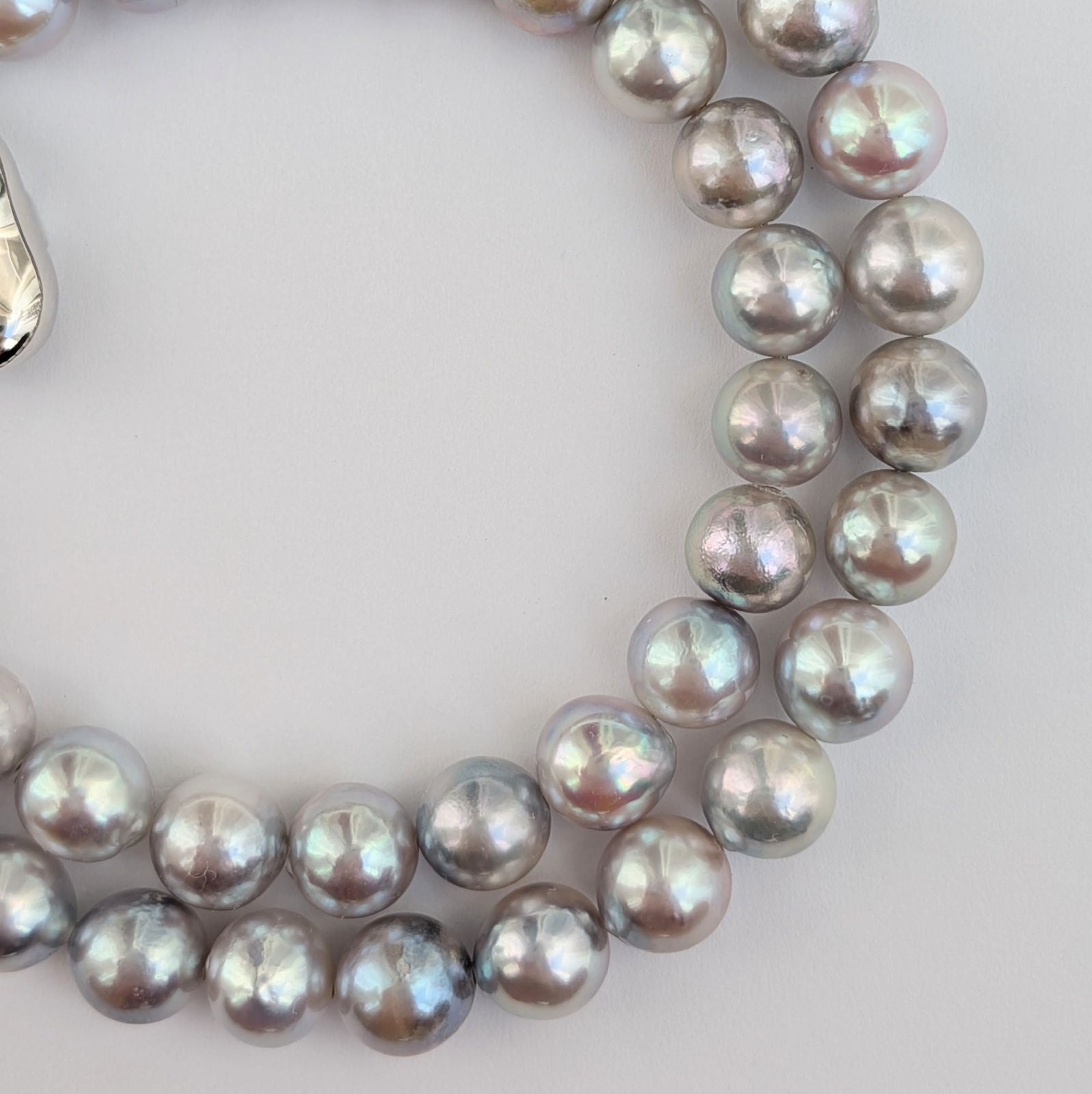 Akoya pearl necklace with natural gray 7-7.5mm pearls and silver fittings displayed on white background
