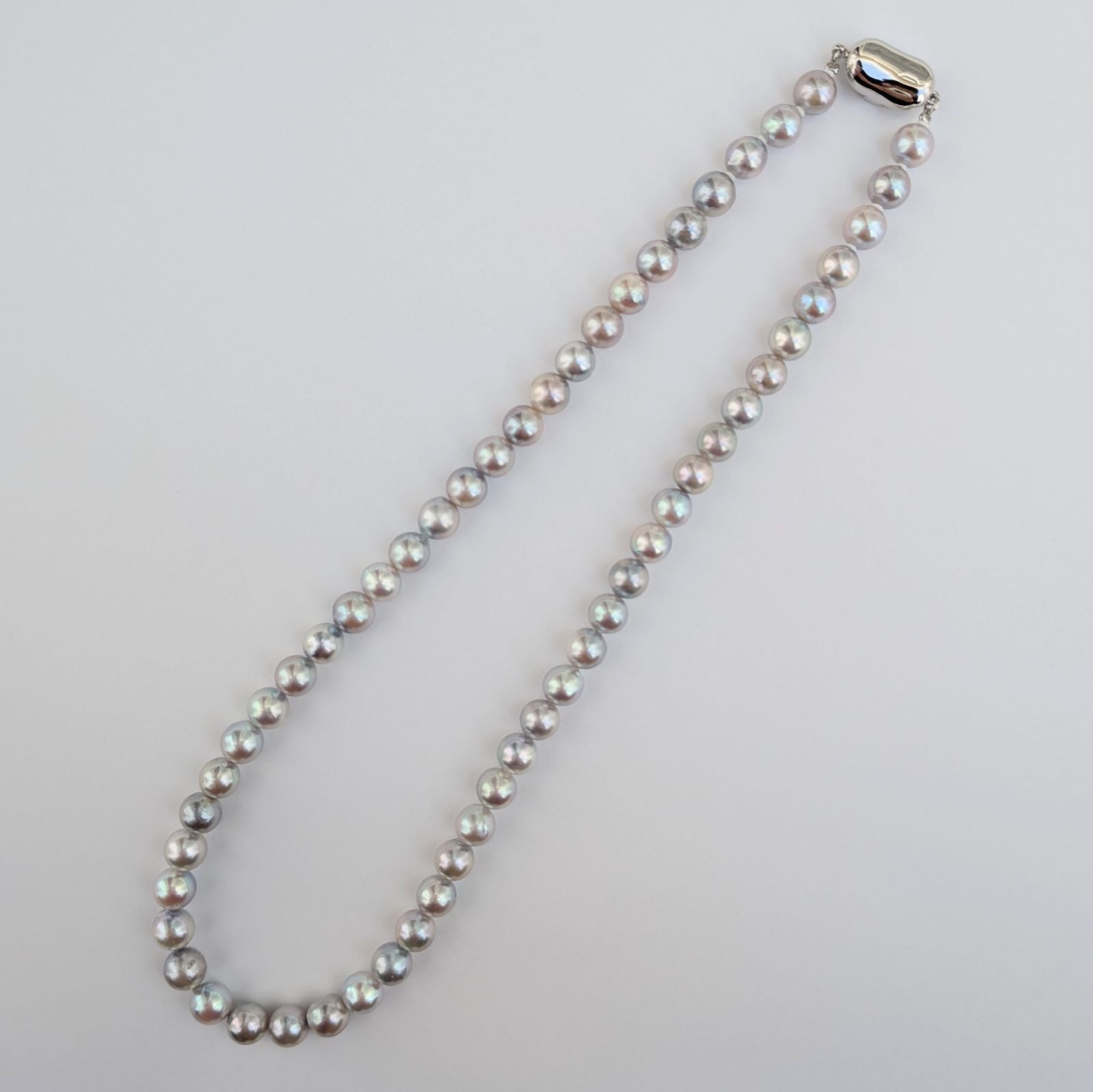 Akoya pearl necklace with natural gray 7-7.5mm pearls and silver fittings displayed on white background