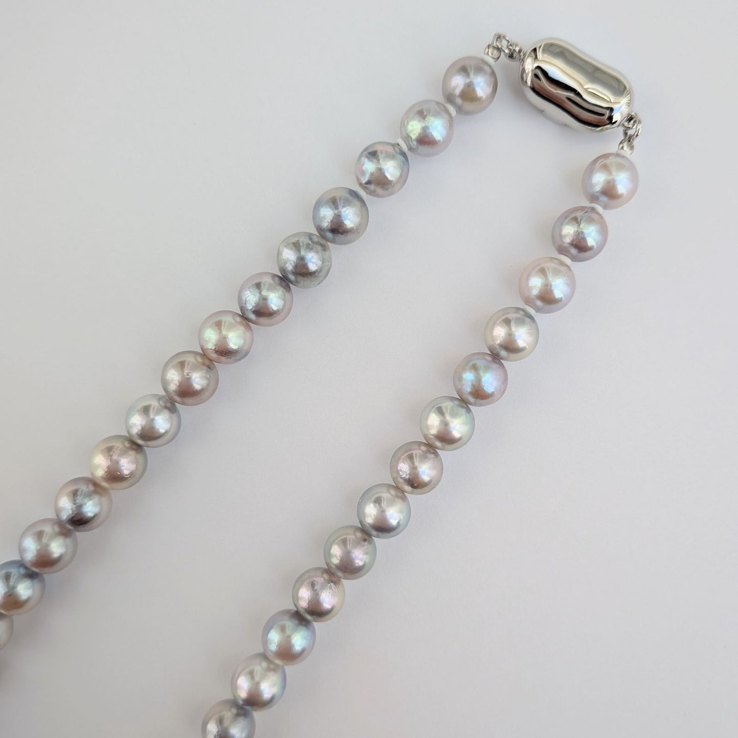 Akoya pearl necklace with natural gray 7-7.5mm pearls and silver fittings displayed on white background