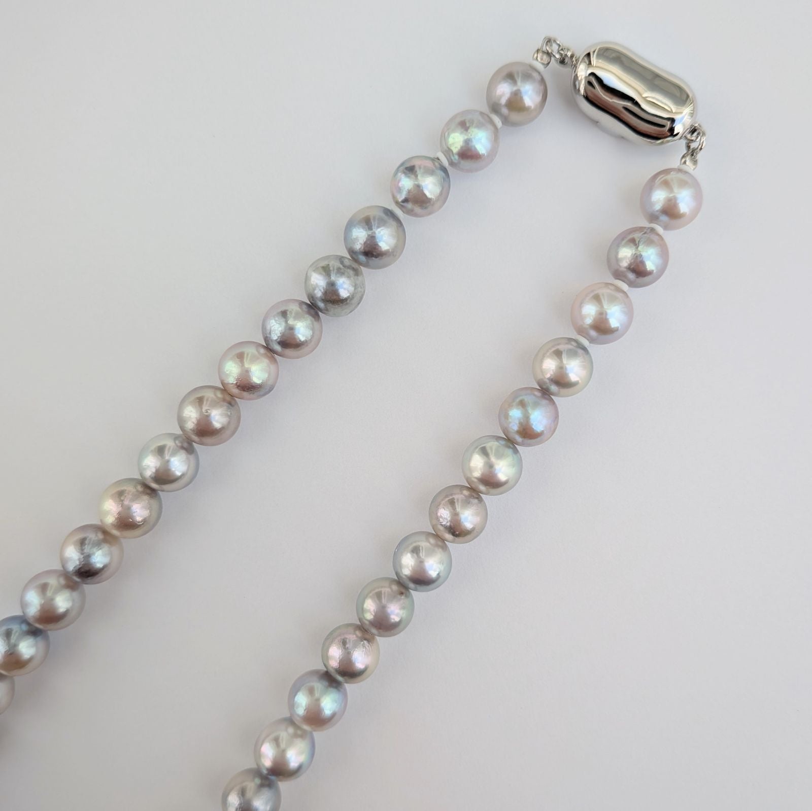 Akoya pearl necklace with natural gray 7-7.5mm pearls and silver fittings displayed on white background