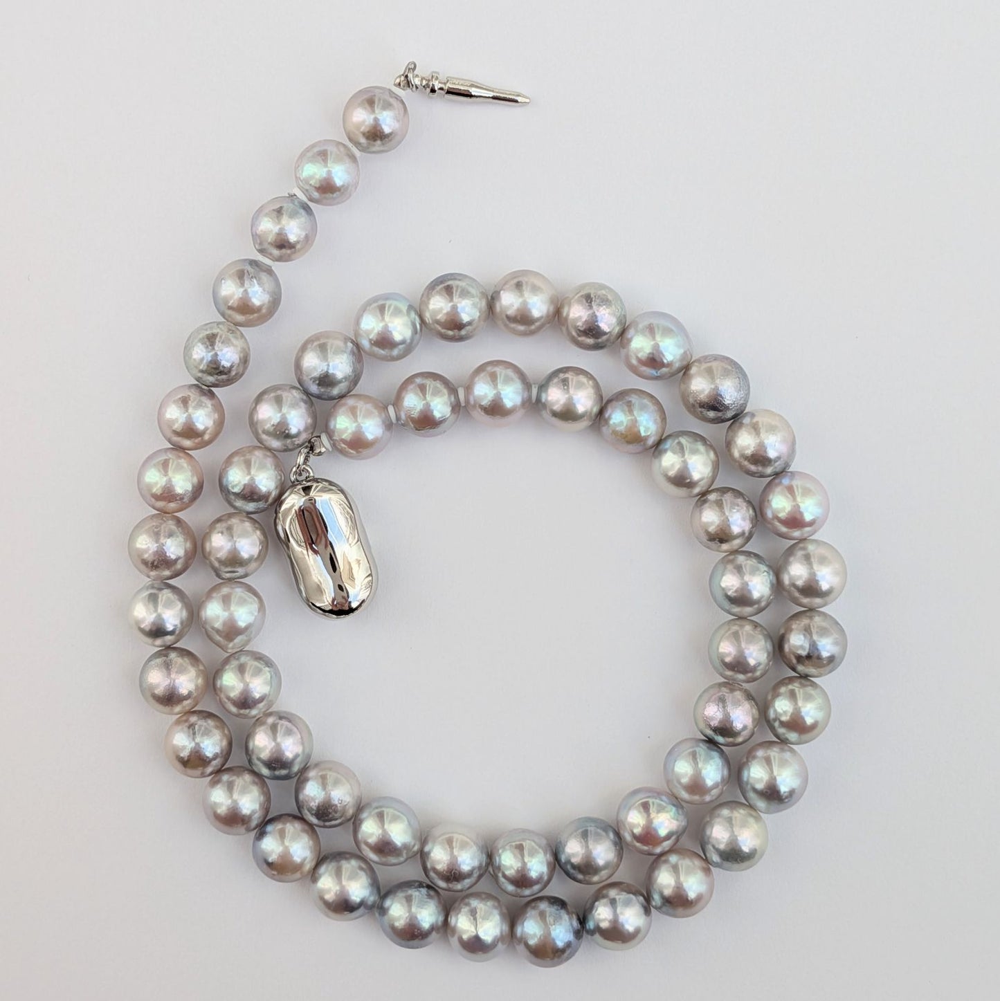 Akoya pearl necklace with natural gray 7-7.5mm pearls and silver fittings displayed on white background