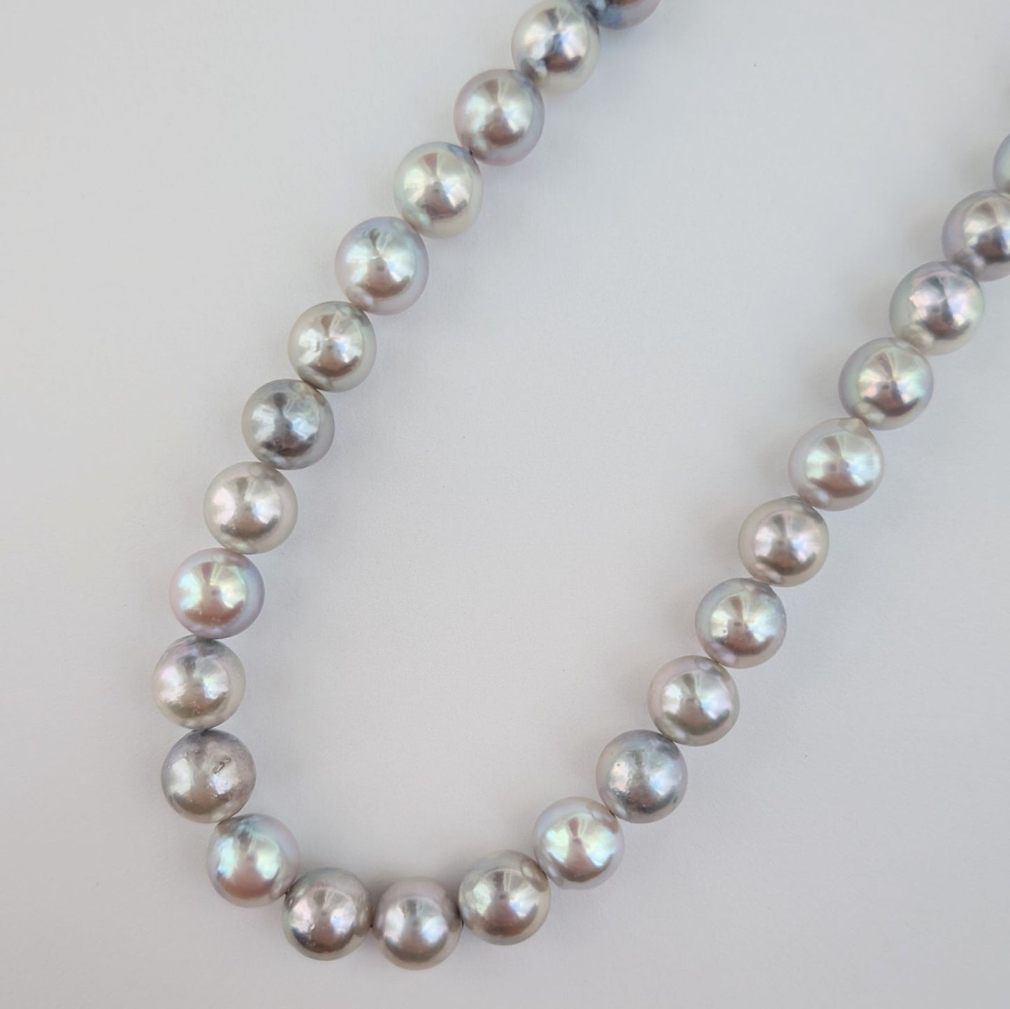 Akoya pearl necklace with natural gray 7-7.5mm pearls and silver fittings displayed on white background