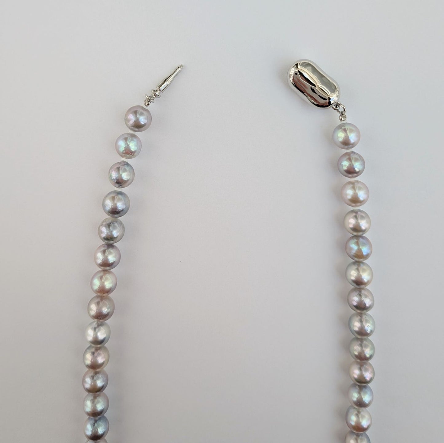 Akoya pearl necklace with natural gray 7-7.5mm pearls and silver fittings displayed on white background