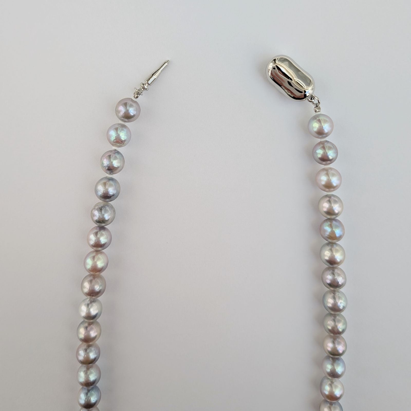 Akoya pearl necklace with natural gray 7-7.5mm pearls and silver fittings displayed on white background