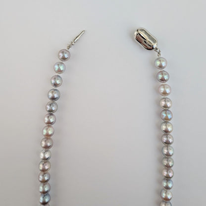 Akoya pearl necklace with natural gray 7-7.5mm pearls and silver fittings displayed on white background