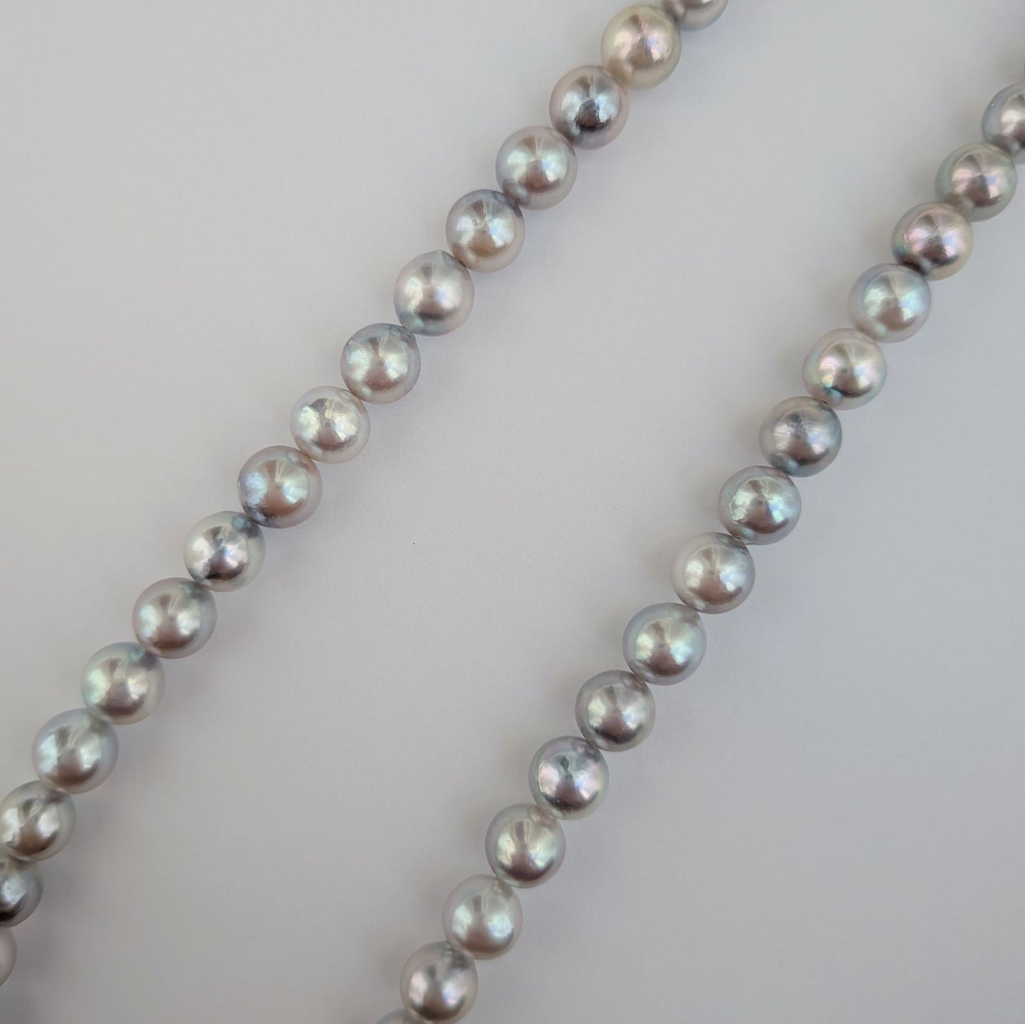 Akoya pearl necklace with natural gray 7-7.5mm pearls and silver fittings displayed on white background