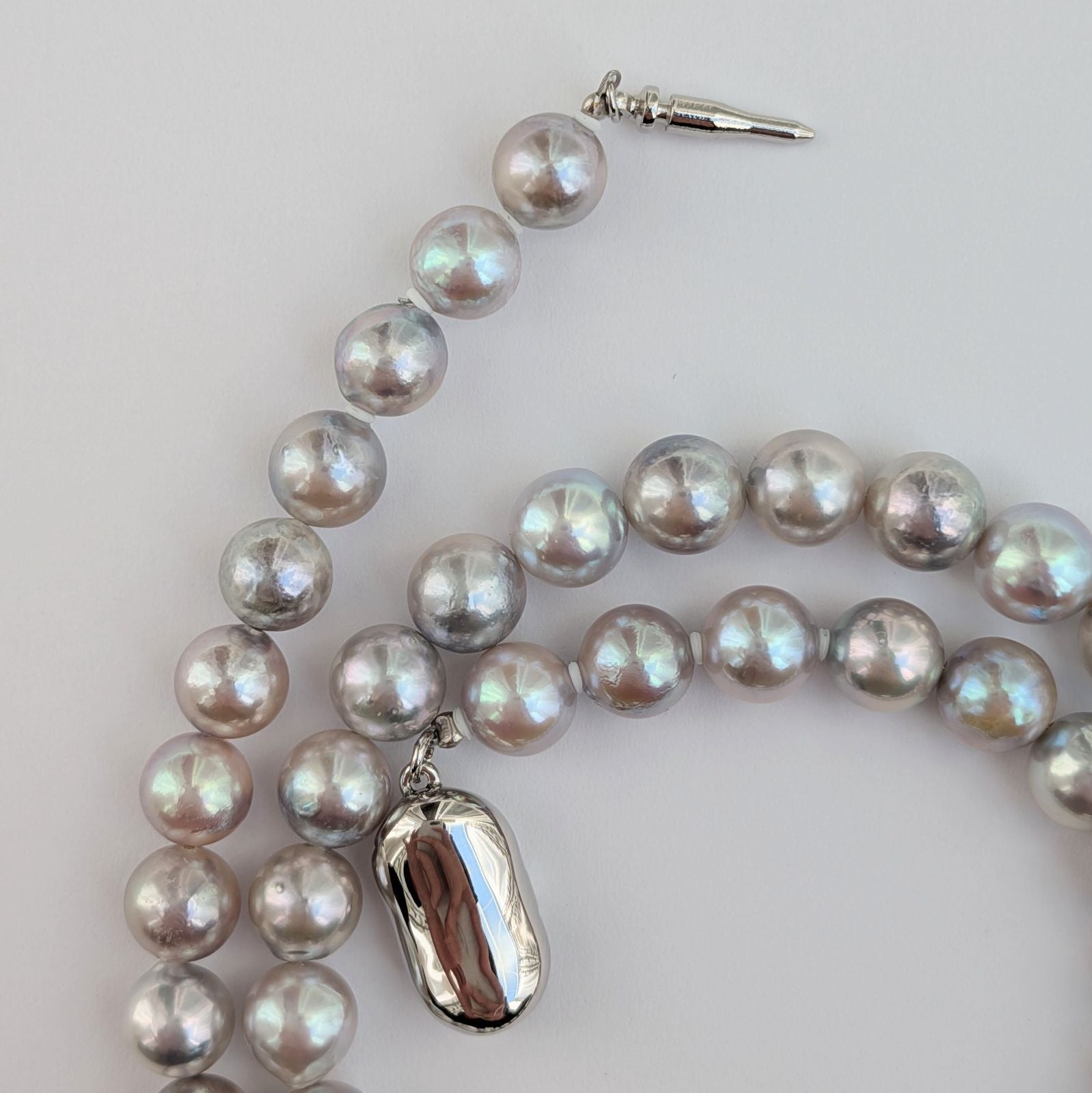 Akoya pearl necklace with natural gray 7-7.5mm pearls and silver fittings displayed on white background