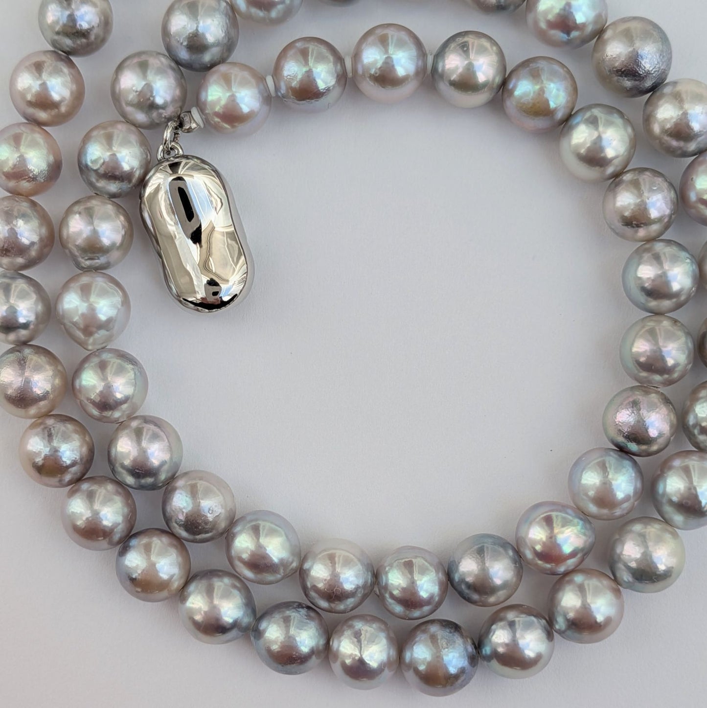 Akoya pearl necklace with natural gray 7-7.5mm pearls and silver fittings displayed on white background