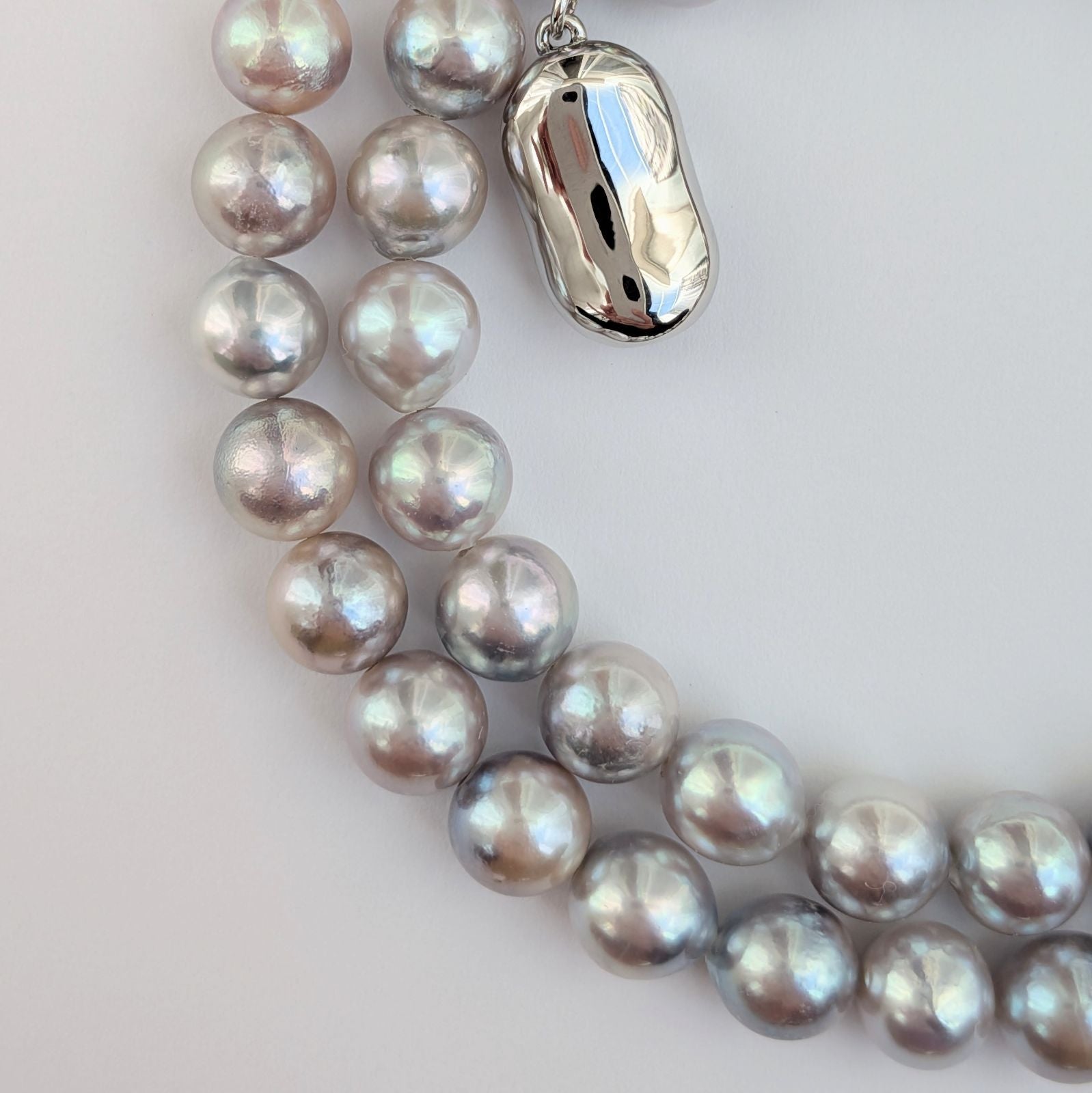 Akoya pearl necklace with natural gray 7-7.5mm pearls and silver fittings displayed on white background