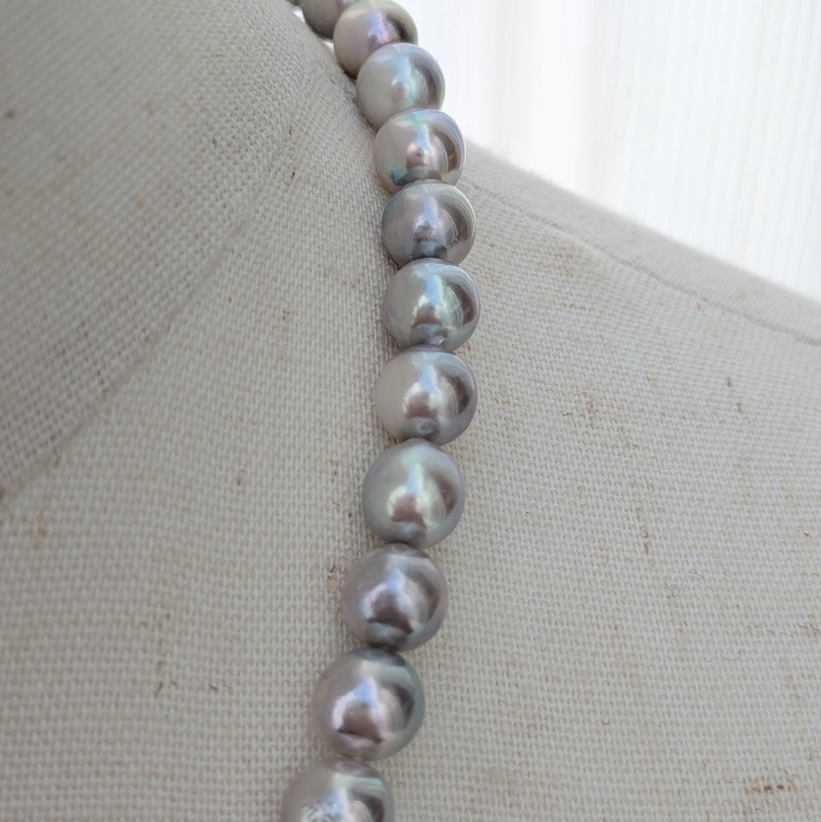 Akoya pearl necklace with natural gray 7-7.5mm pearls and silver fittings displayed on white background