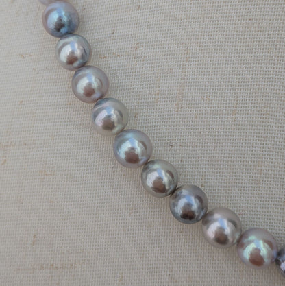 Akoya pearl necklace with natural gray 7-7.5mm pearls and silver fittings displayed on white background
