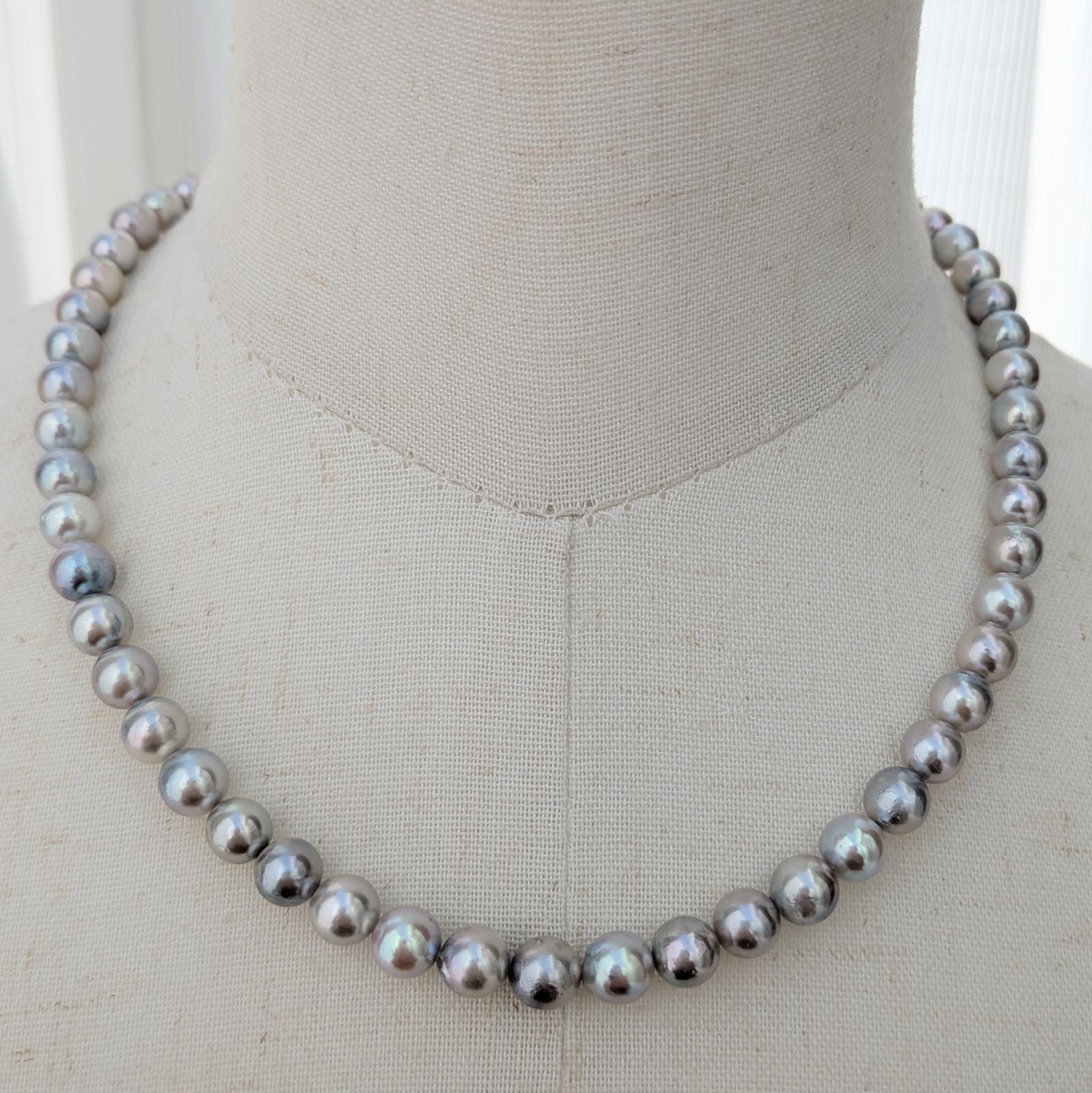 Akoya pearl necklace with natural gray 7-7.5mm pearls and silver fittings displayed on white background