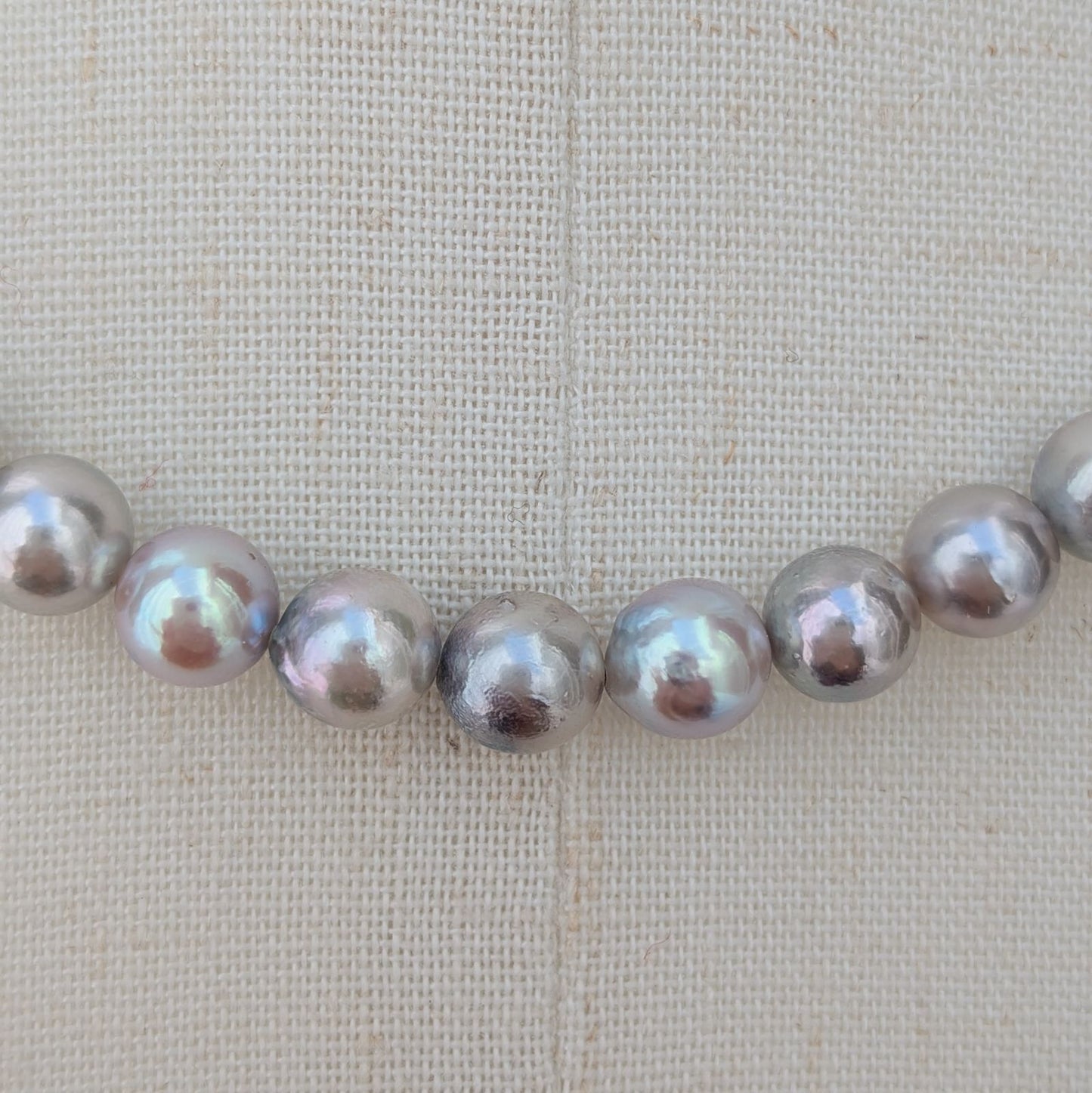 Akoya pearl necklace with natural gray 7-7.5mm pearls and silver fittings displayed on white background