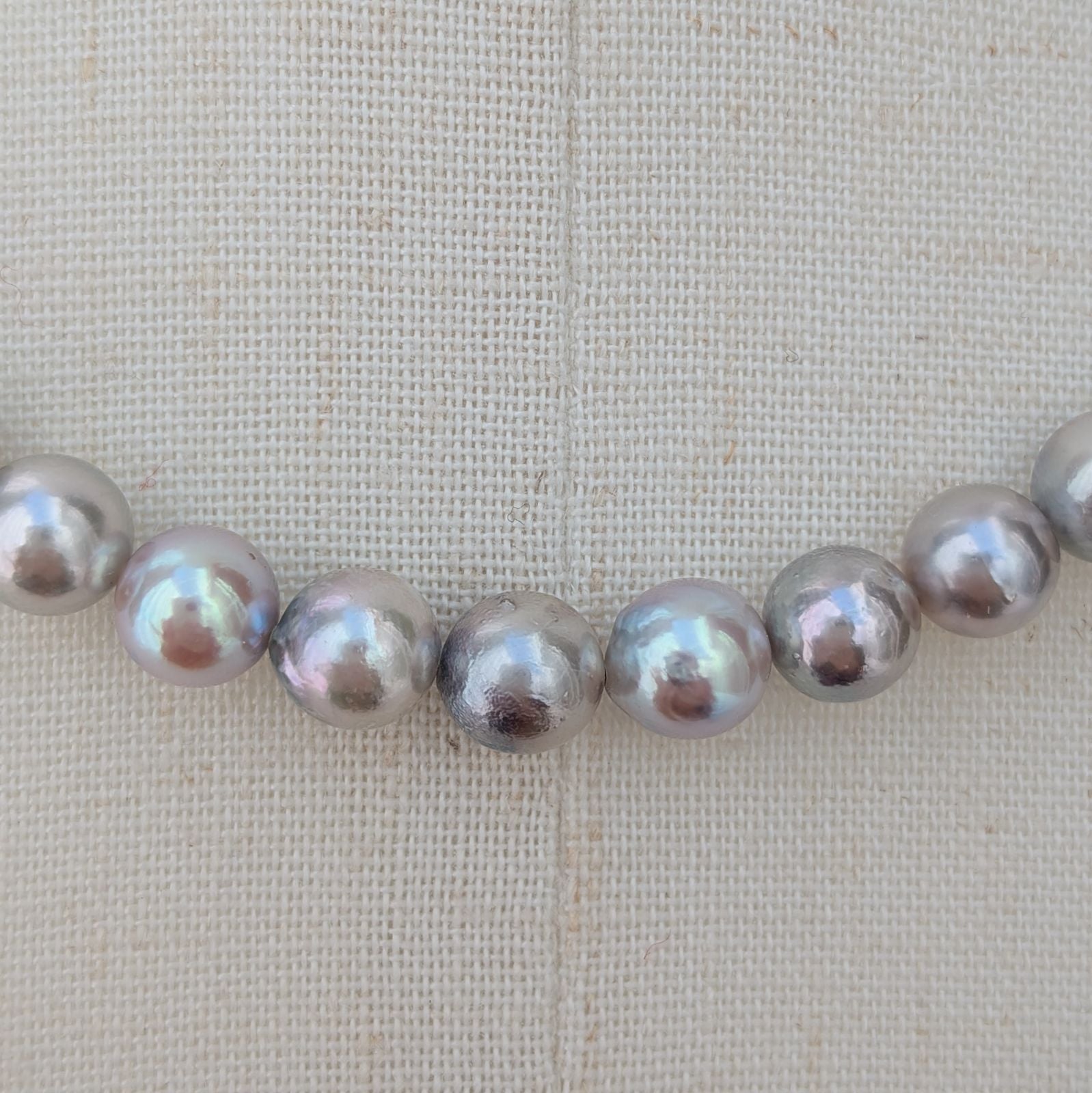 Akoya pearl necklace with natural gray 7-7.5mm pearls and silver fittings displayed on white background