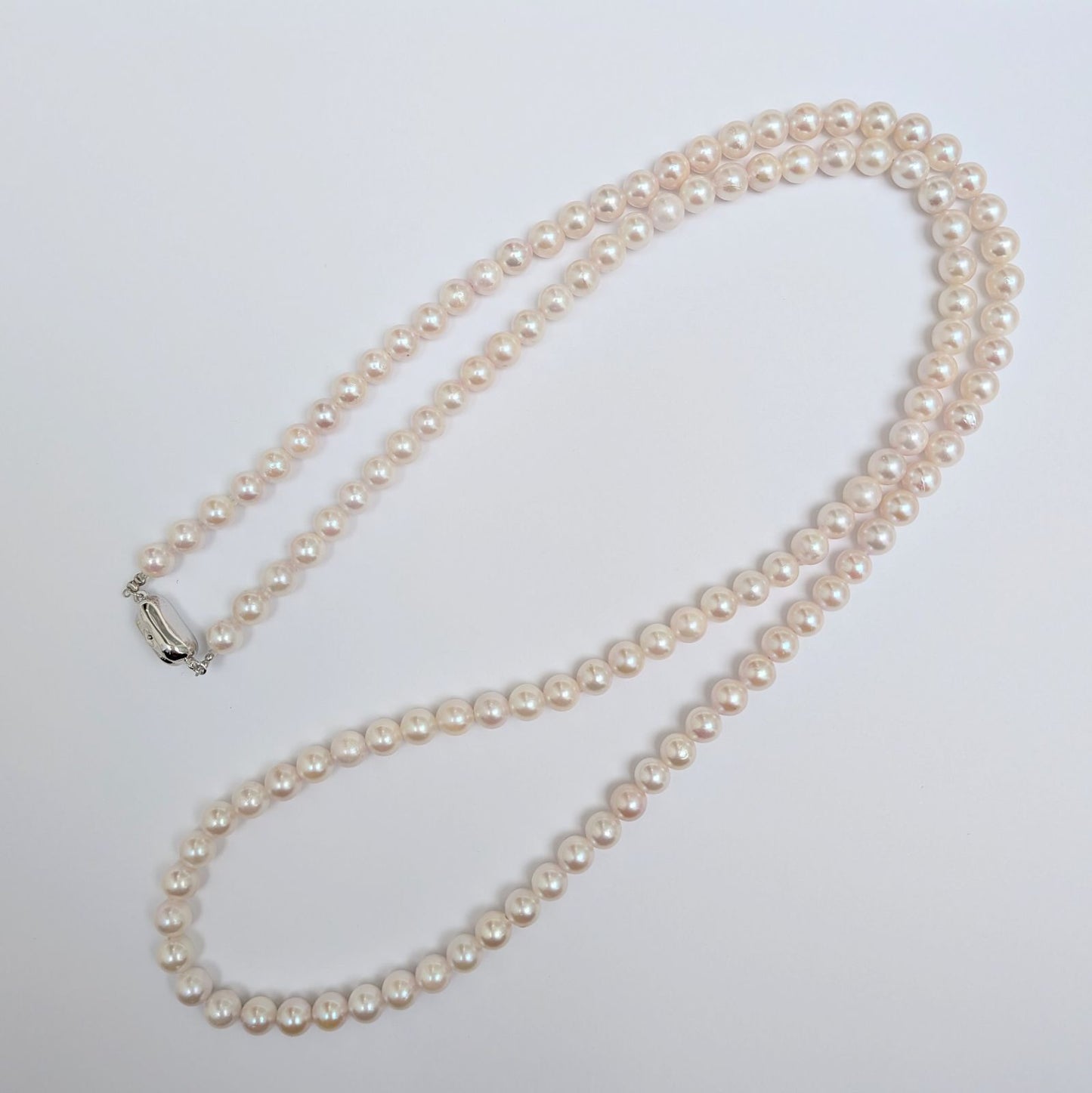 Long Akoya pearl necklace with round 6.5-7mm pink tone pearls and silver clasp, 82 cm length