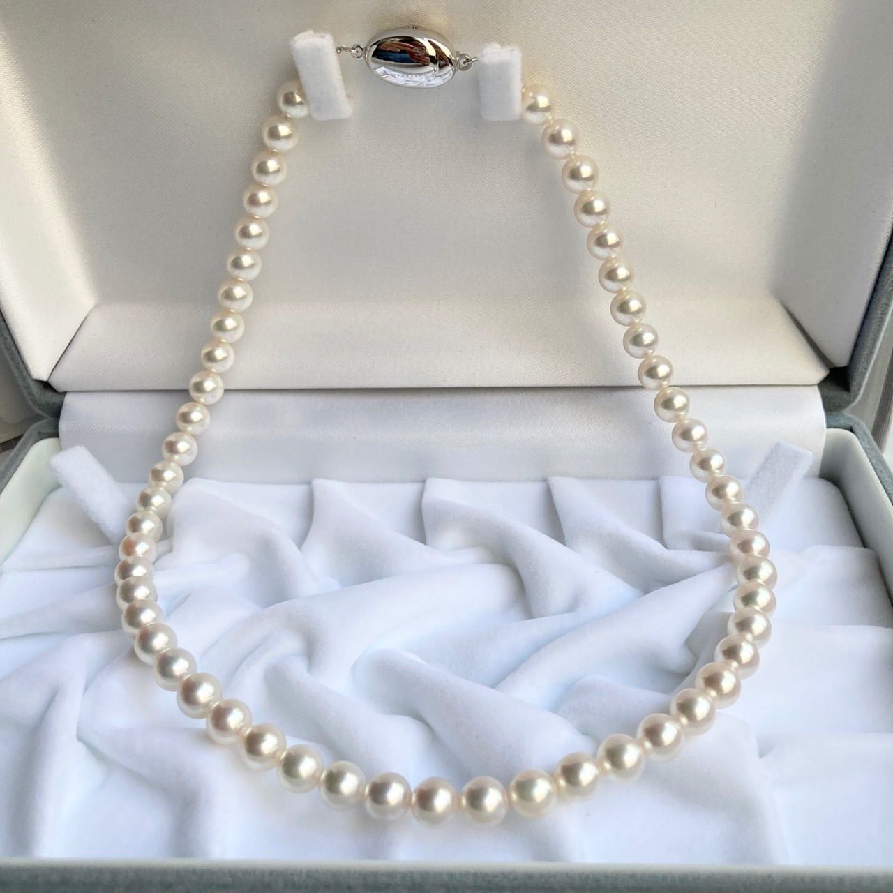 Akoya pearl necklace 40cm length with 6.5-7.0mm pearls and silver clasp displayed with certificate and case