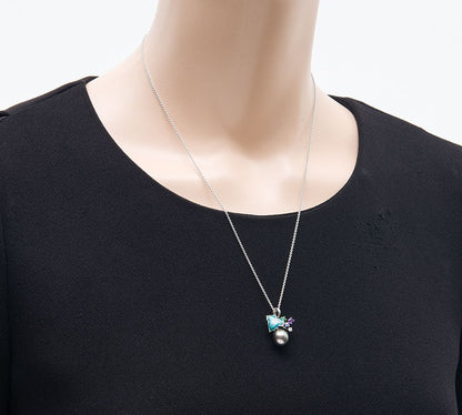 Mikimoto pendant necklace with drop-shaped black South Sea pearl and botanical motif in 18K white gold