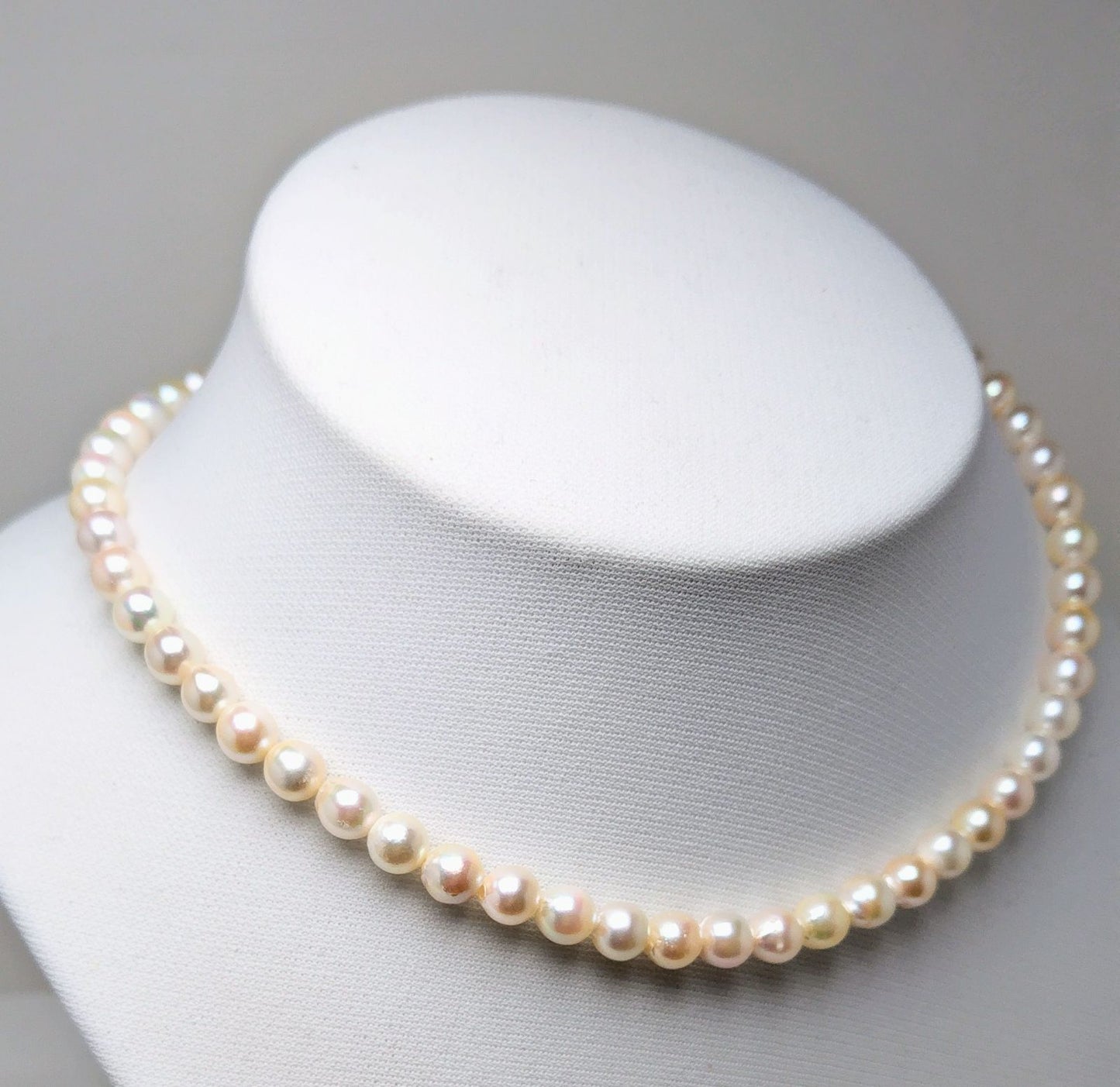 Akoya pearl necklace with 6.5 to 7.0 mm white pink semi-baroque pearls showing natural indentations and good luster