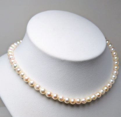 Akoya pearl necklace with 6.5 to 7.0 mm white pink semi-baroque pearls showing natural indentations and good luster