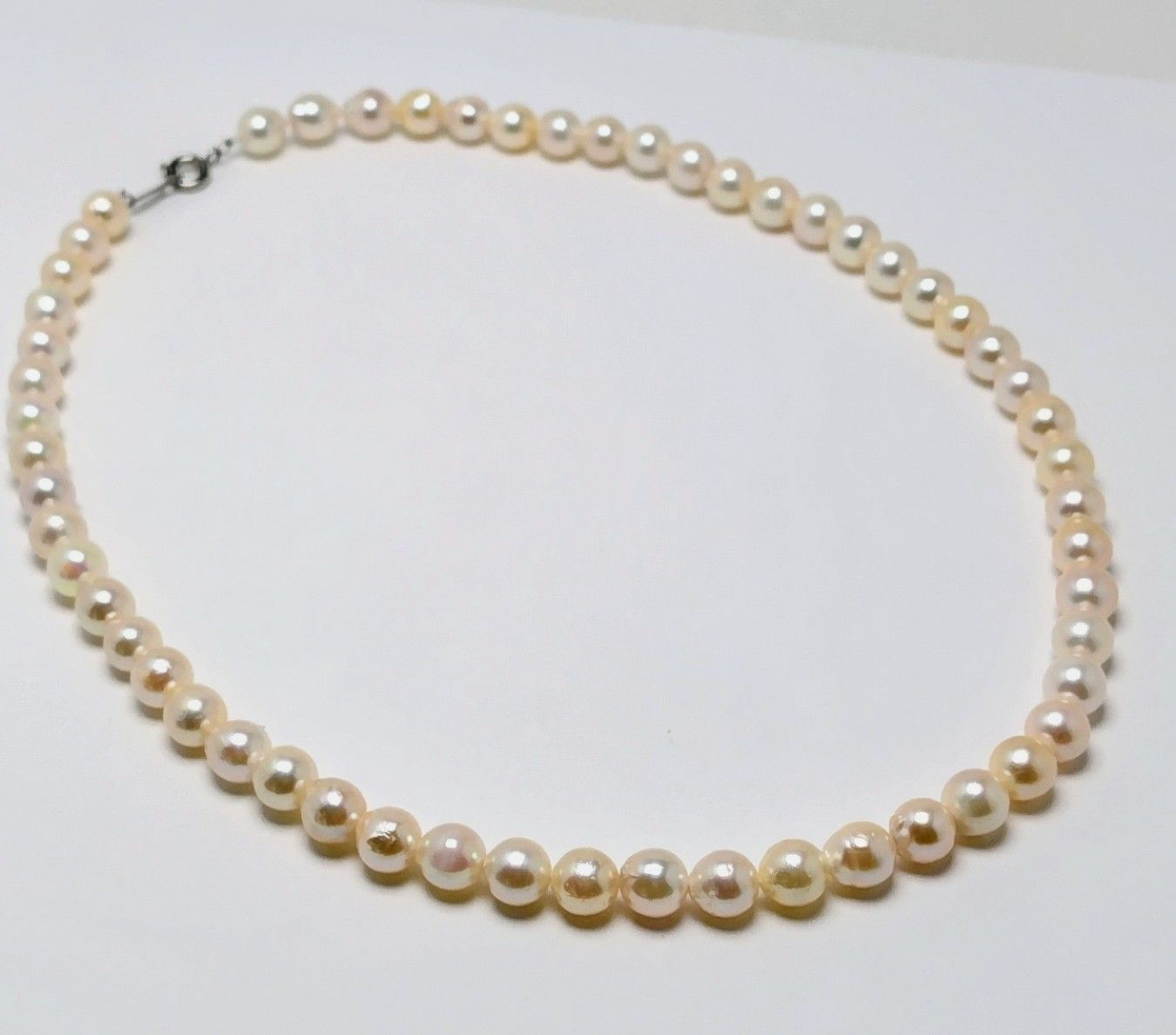Akoya pearl necklace with 6.5 to 7.0 mm white pink semi-baroque pearls showing natural indentations and good luster
