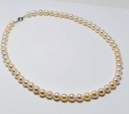 Akoya pearl necklace with 6.5 to 7.0 mm white pink semi-baroque pearls showing natural indentations and good luster