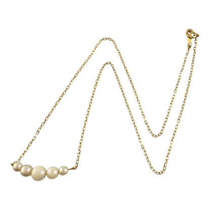 Mikimoto 18K yellow gold pearl necklace for ladies weighing 2.3 grams shown on white background
