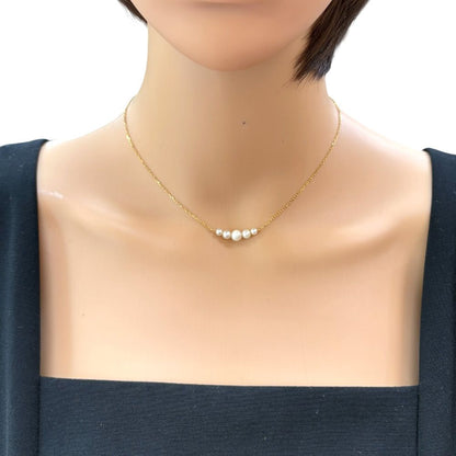 Mikimoto 18K yellow gold pearl necklace for ladies weighing 2.3 grams shown on white background