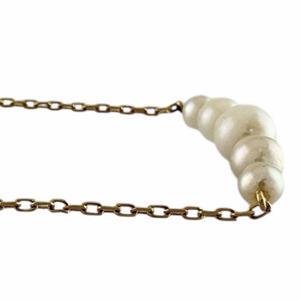 Mikimoto 18K yellow gold pearl necklace for ladies weighing 2.3 grams shown on white background