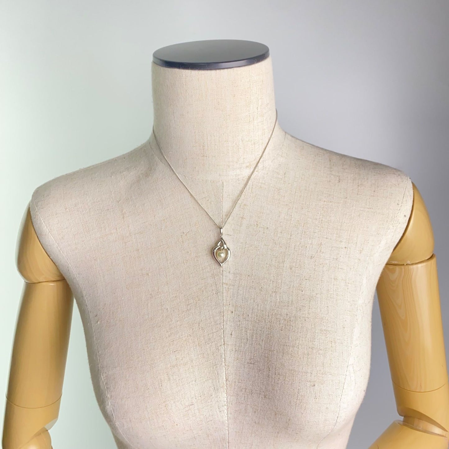 Mikimoto pearls necklace showing white pearls with slight cloudiness due to aging