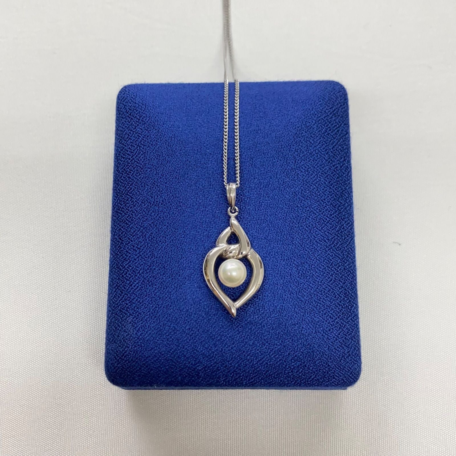 Mikimoto pearls necklace showing white pearls with slight cloudiness due to aging