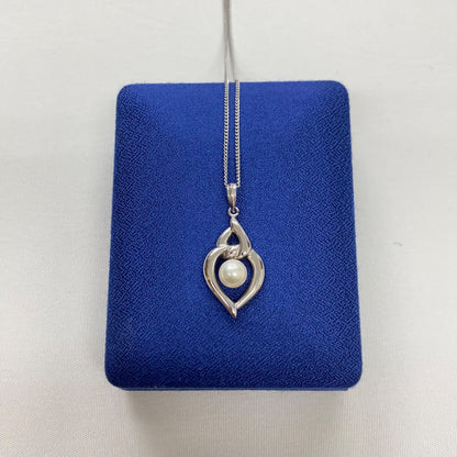 Mikimoto pearls necklace showing white pearls with slight cloudiness due to aging