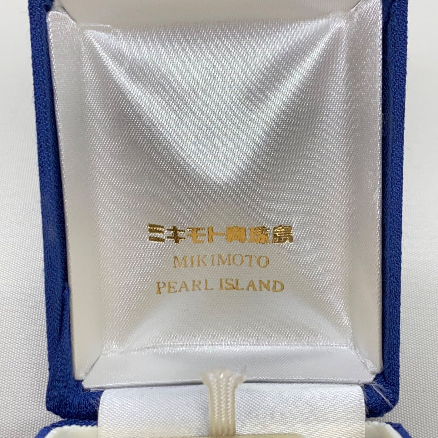 Mikimoto pearls necklace showing white pearls with slight cloudiness due to aging
