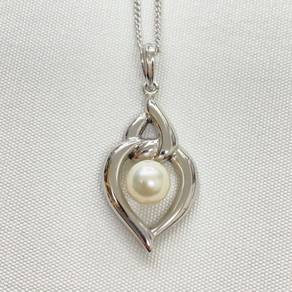 Mikimoto pearls necklace showing white pearls with slight cloudiness due to aging
