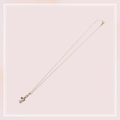 Mikimoto 18K yellow gold pendant necklace with ruby and 5.1mm Akoya pearl on 38cm chain displayed with box