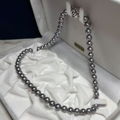 Akoya genuine pearl necklace in gray with mixed navy and purple tones, paired with silk Juzu bracelet