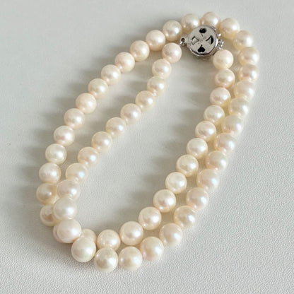 Akoya pearl necklace with 7.1-7.4mm round pearls and 43cm silver chain displayed on white background