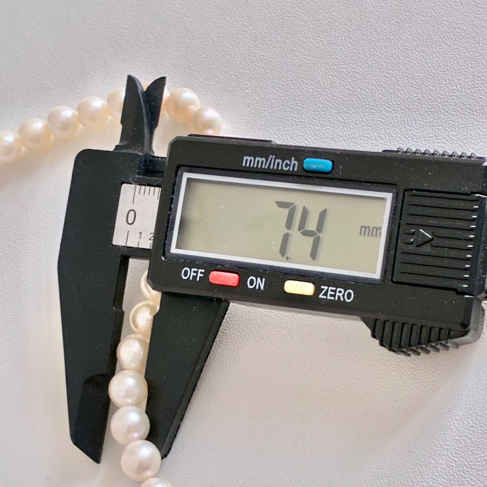 Akoya pearl necklace with 7.1-7.4mm round pearls and 43cm silver chain displayed on white background