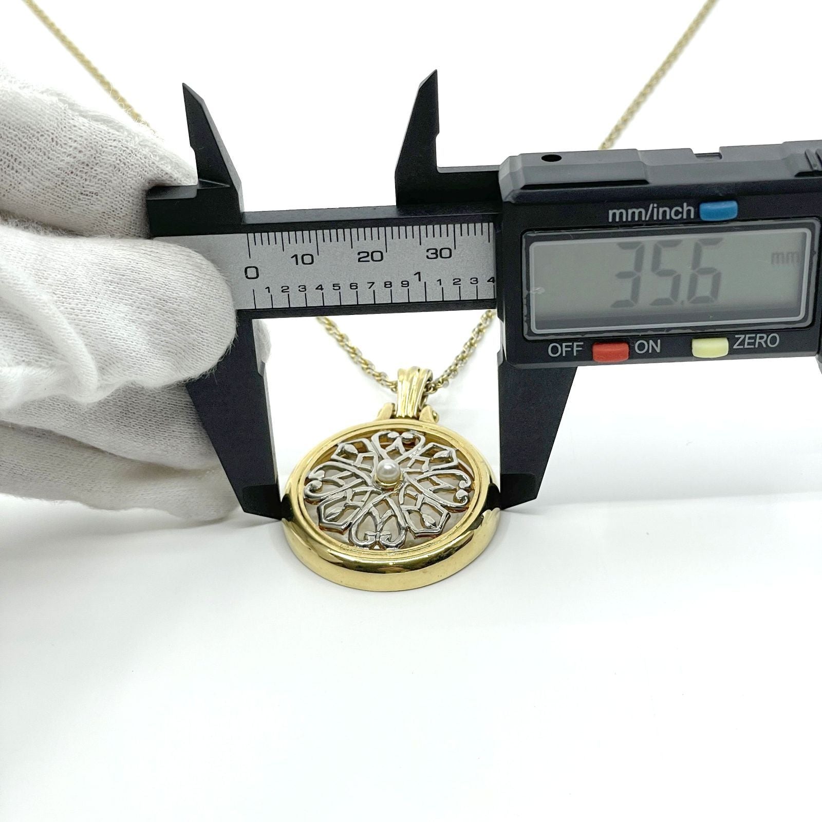 Mikimoto Loupe Pendant Necklace featuring a pearl magnifier on a 64 chain with moderate scratches