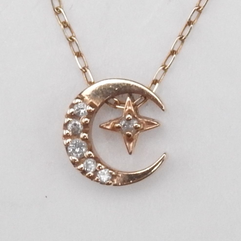 Agete pink gold necklace with 0.05ct diamonds featuring hollow moon and star motifs