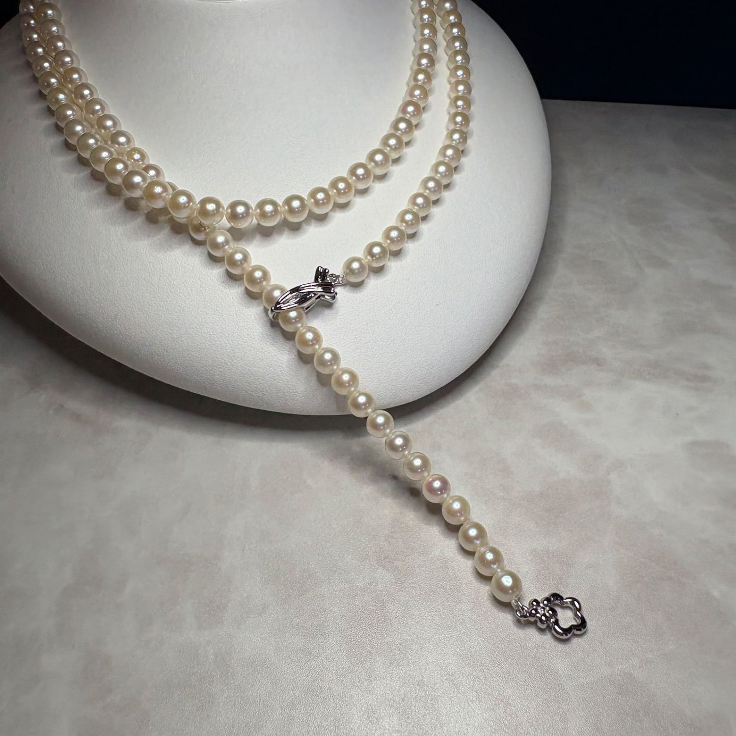 Akoya genuine pearl necklace 82 cm long with 5.5-6.0mm ivory pearls and silver clip fittings showing slight wear