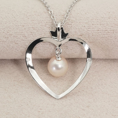 Mikimoto heart-shaped pearl necklace with silver chain displayed against white background