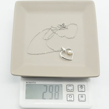 Mikimoto heart-shaped pearl necklace with silver chain displayed against white background
