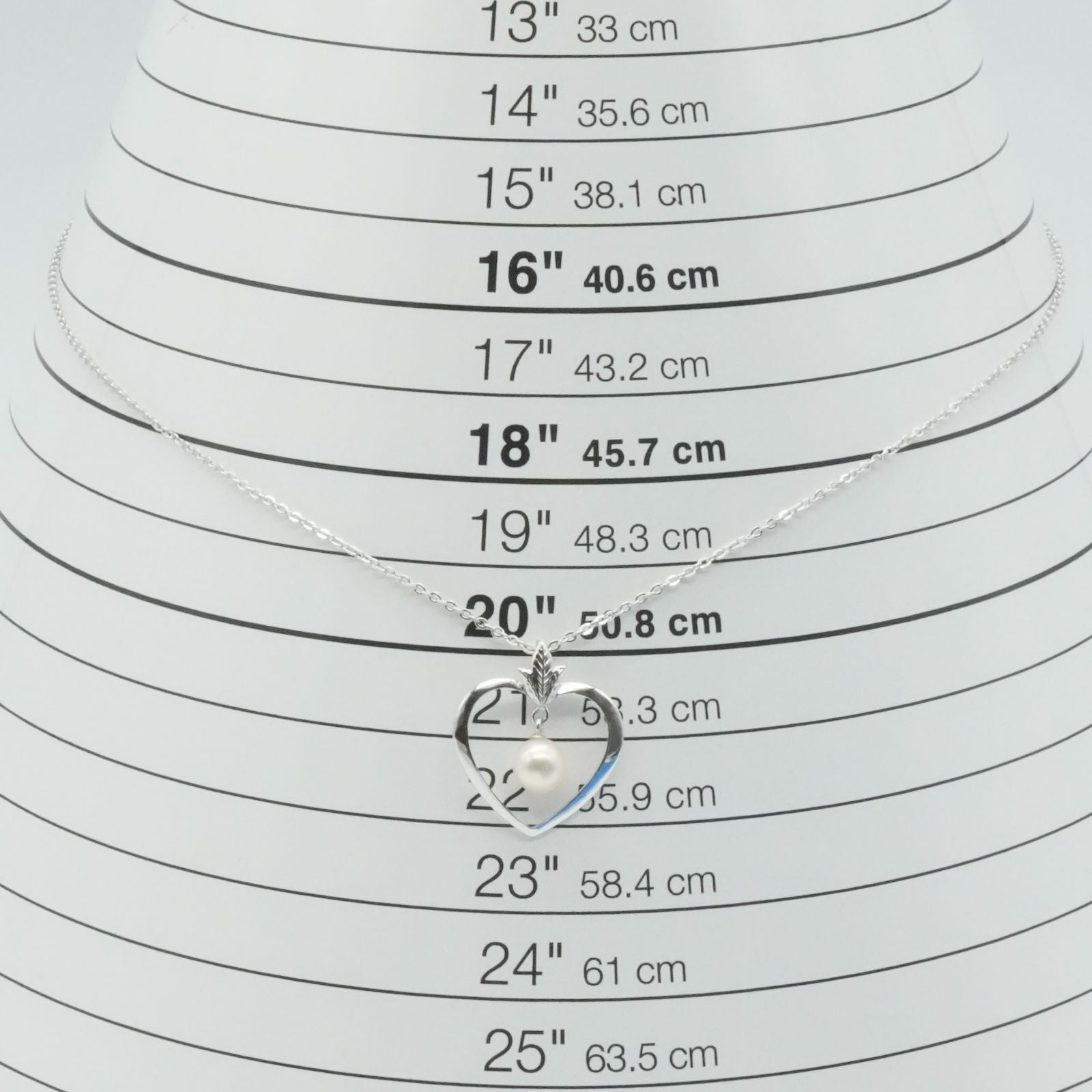 Mikimoto heart-shaped pearl necklace with silver chain displayed against white background