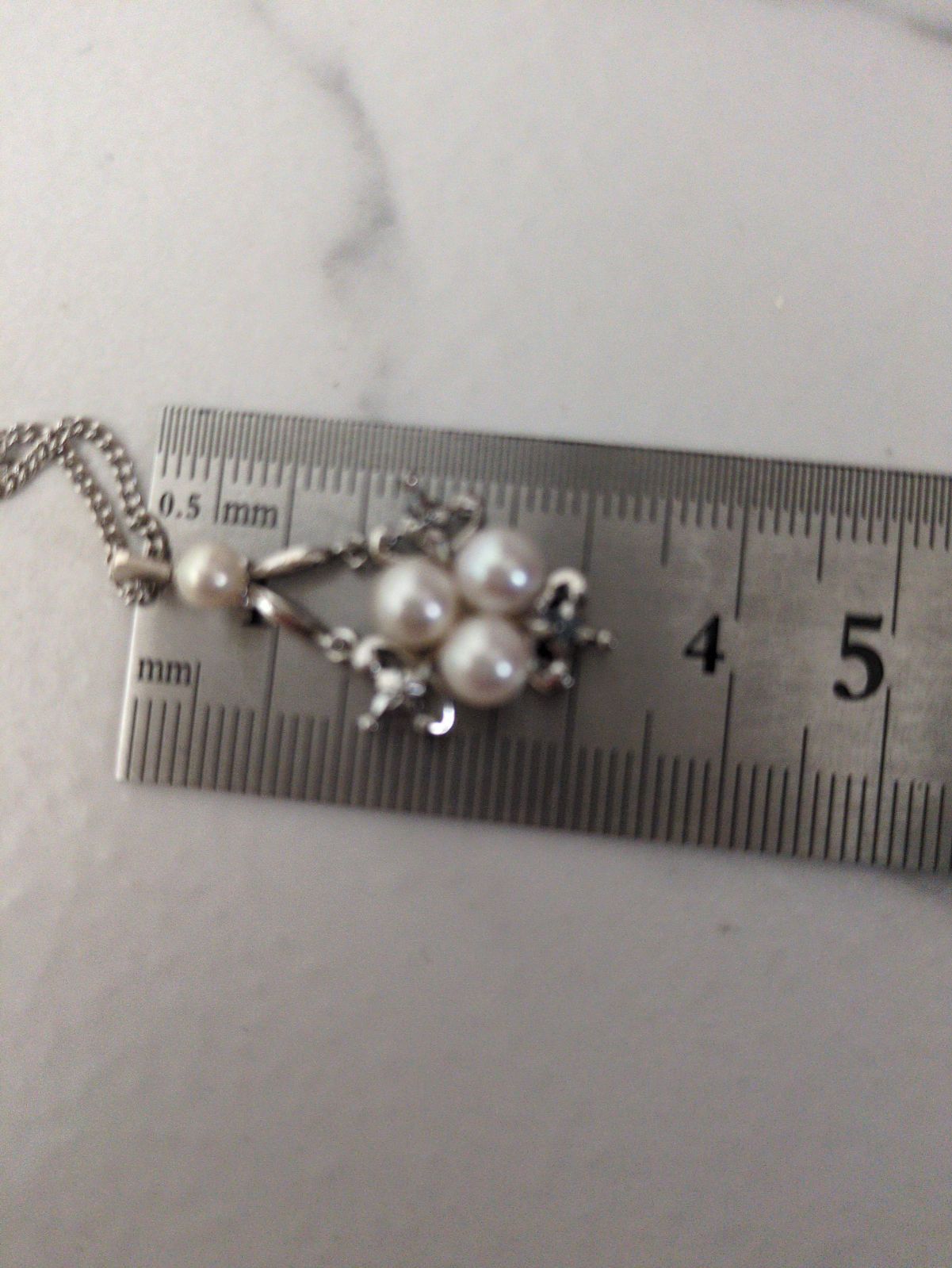 Close-up of a Mikimoto Pearl Necklace featuring lustrous genuine pearls on a delicate string