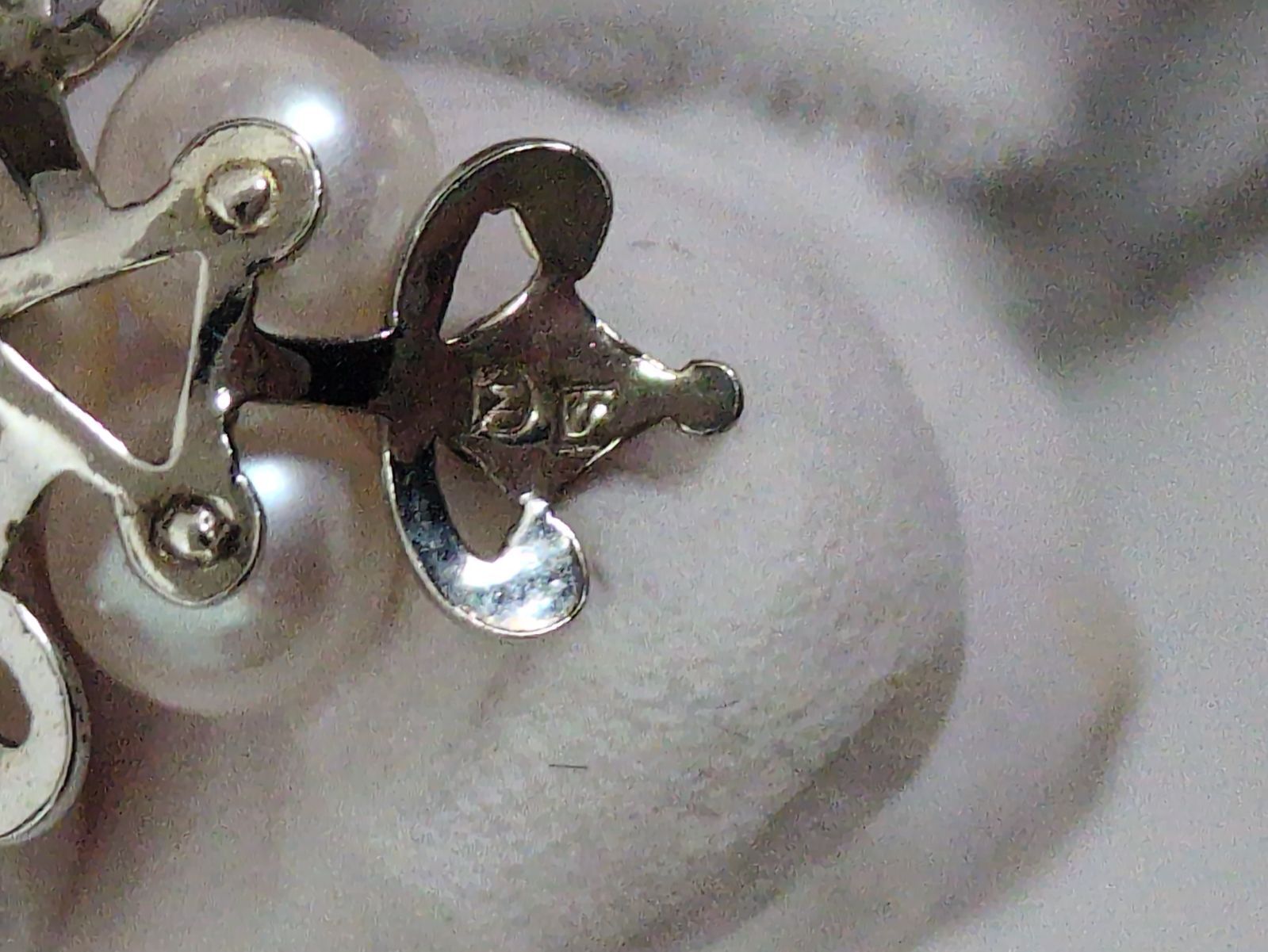 Close-up of a Mikimoto Pearl Necklace featuring lustrous genuine pearls on a delicate string