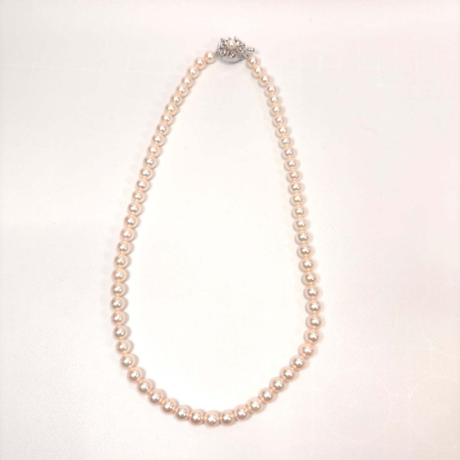 Akoya pearl necklace with 6mm real pearls and silver clasp displayed on a white background