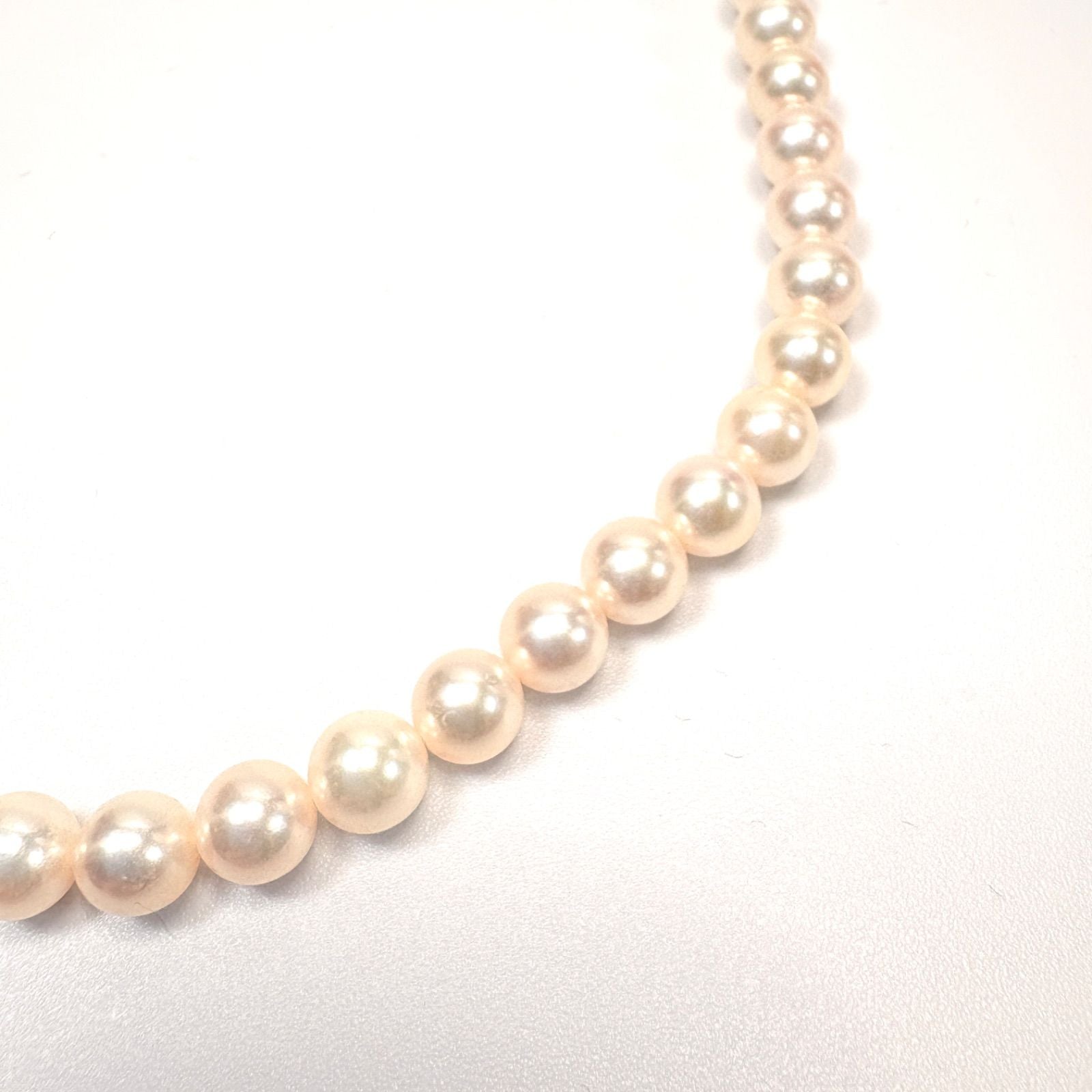 Akoya pearl necklace with 6mm real pearls and silver clasp displayed on a white background