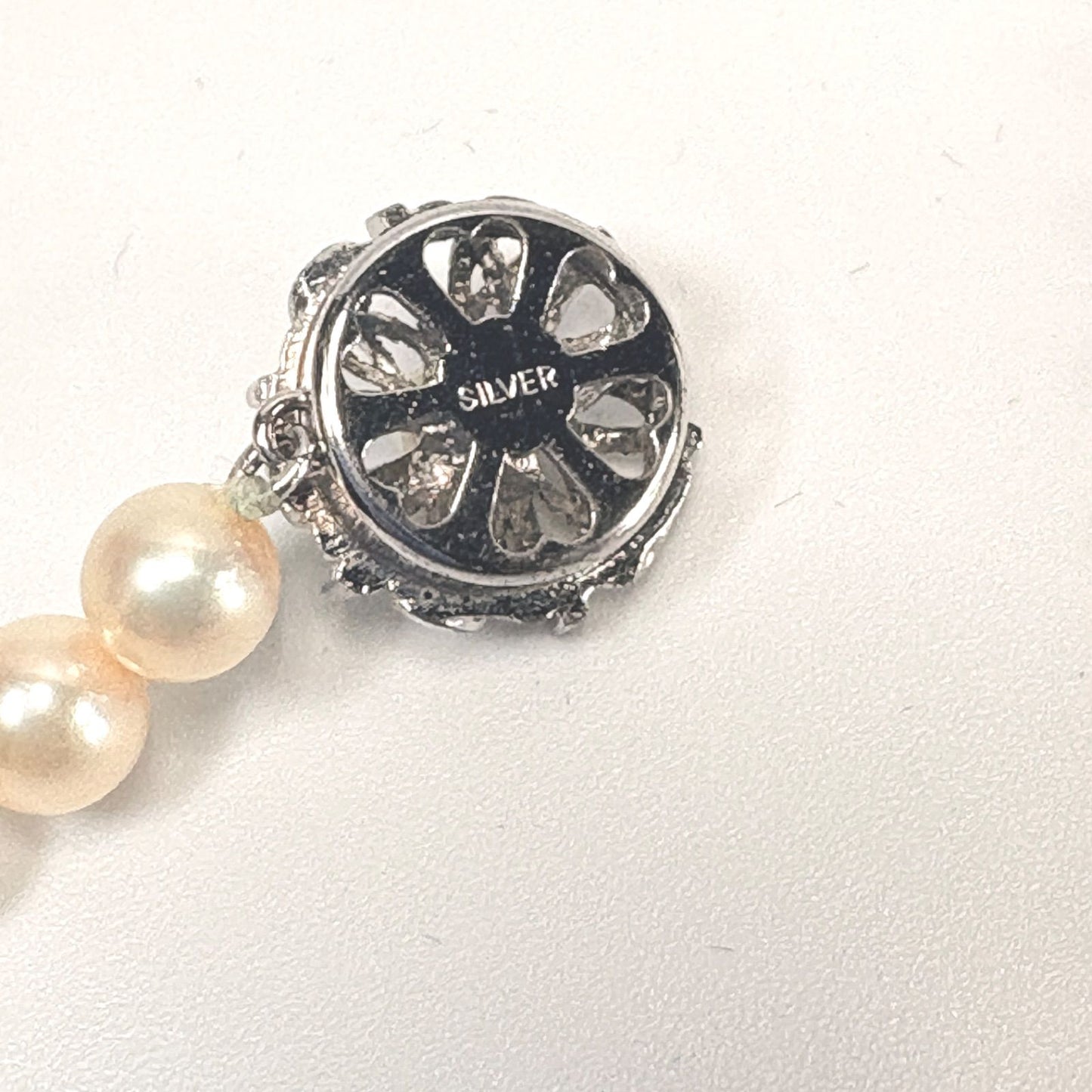 Akoya pearl necklace with 6mm real pearls and silver clasp displayed on a white background